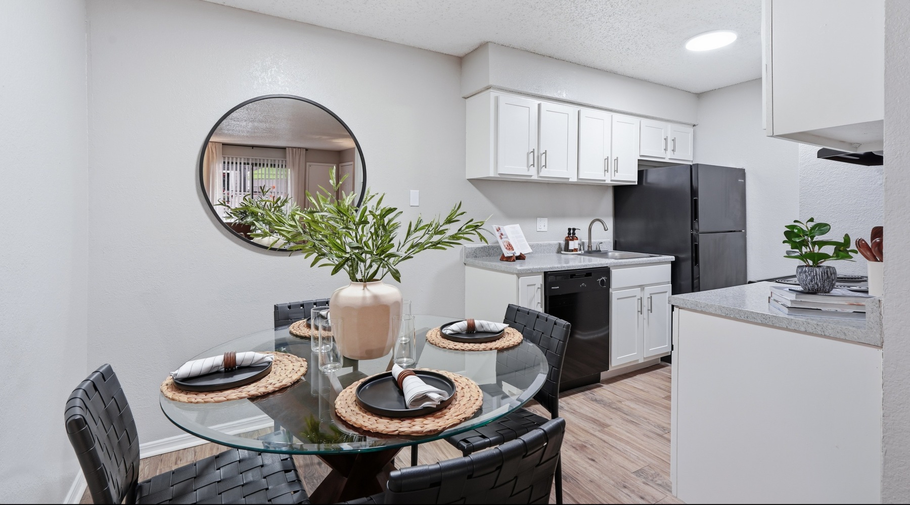 Diningroom with 4 seat table looking into kitchen 