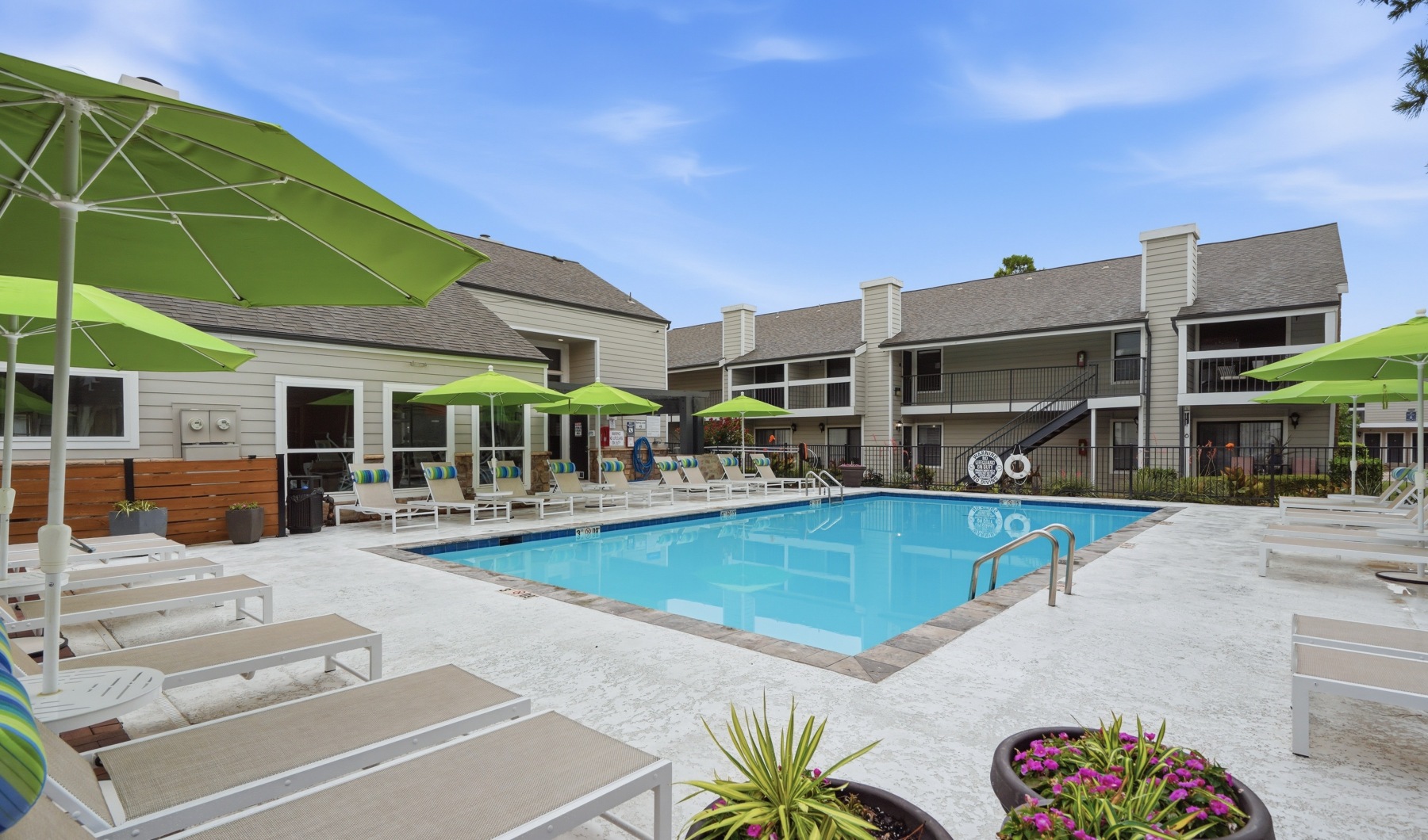 Community Pool with tanning loungers and umbrellas